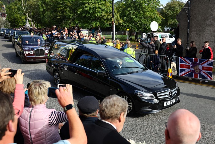 The hearse carrying the coffin of Britains Queen Elizabeth passes through the village of Ballater, near Balmoral, Scotland, Britain, September 11, 2022. REUTERS/Kai Pfaffenbach
