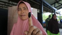 Warga menunjukkan tinta di jari telunjukbnya seusai memberikan hak pilihnya pada Pemilihan Keuchik Langsung (Pilchiksung) atau Pemilihan Kepala Desa (Pilkades) serentak di Desa Suak Timah, Samatiga, Aceh Barat, Aceh, Minggu (11/9/2022).