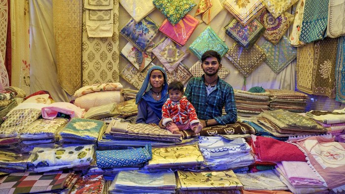 Prem Singh, who travelled from Hoshiarpur in Punjab, sells footwear and clothes at his stall at a local fair in Dharmsala, India, Sunday, Sept. 4, 2022. In small north Indian towns, some enterprising men and women move from place to place with bags full of colorful wares to sell at local fairs, keeping centuries-old traditions alive when roving fairs were the main vehicle of commerce. (AP Photo/Ashwini Bhatia)