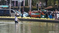 Salah satu massa tercebur di kolam di bundaran dekat Patung Kuda.