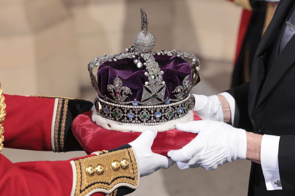 The Imperial State Crown arrives through the Sovereign's Entrance ahead of the State Opening of Parliament at Houses of Parliament in London, Tuesday, May 10, 2022. Britain’s Parliament opens a new year-long session on Tuesday with a mix of royal pomp and raw politics, as Prime Minister Boris Johnson tries to re-energize his scandal-tarnished administration and revive the economy amid a worsening cost-of-living crisis. (Chris Jackson/Pool Photo via AP)