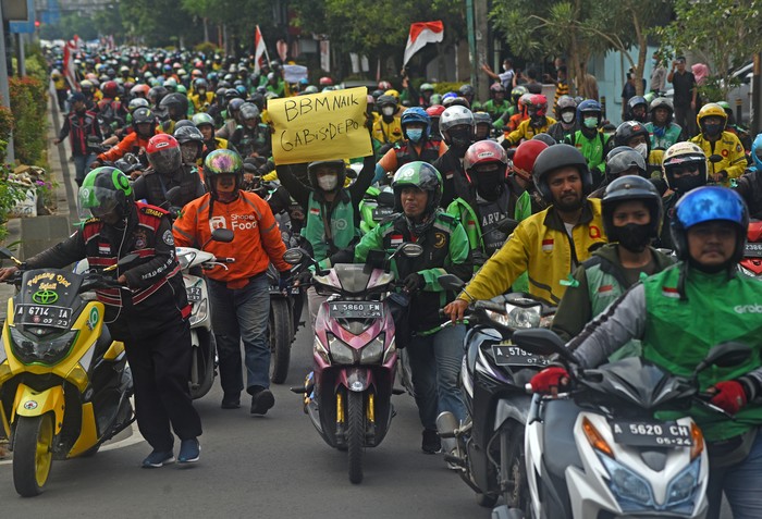 Sejumlah pengemudi ojek online (ojol) melakukan konvoi saat berunjuk rasa di alun-alun Serang, Banten, Senin (12/9/2022). Mereka menuntut kenaikan pendapatan serta peningkatan kesejahteraan setelah pemerintah menaikkan harga bahan bakar minyak (BBM). ANTARA FOTO/Asep Fathulrahman/aww.