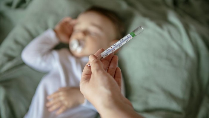 Sick baby with high fever. Shadow DOF. Developed from RAW; retouched with special care and attention; Small amount of grain added for best final impression. 16 bit Adobe RGB color profile.