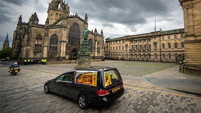 Iringan Jenazah Ratu Elizabeth II Disambut Ribuan Warga Inggris EDINBURGH, SCOTLAND - SEPTEMBER 11: The hearse carrying the coffin of Queen Elizabeth II arrives at Palace of Holyroodhouse, Edinburgh, where she will lie overnight and then be moved to St Giles Catherdral on September 11, 2022 in Edinburgh, United Kingdom. Elizabeth Alexandra Mary Windsor was born in Bruton Street, Mayfair, London on 21 April 1926. She married Prince Philip in 1947 and ascended the throne of the United Kingdom and Commonwealth on 6 February 1952 after the death of her Father, King George VI. Queen Elizabeth II died at Balmoral Castle in Scotland on September 8, 2022, and is succeeded by her eldest son, King Charles III.