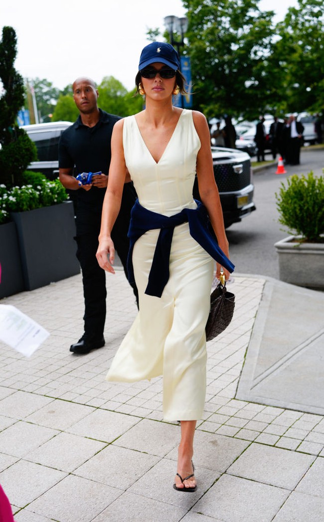 Kendall Jenner tampil sporty elegan saat menonton final US Open 2022 bersama Devin Booker. Dia mengenakan dress satin berwarna krem berpotongan v-neck yang dipadukan dengan sweater biru yang disampirkan di bahunya. Kendall juga memakai topi Polo yang senada dengan sweaternya. Foto: Gotham/GC Images