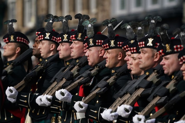 WINDSOR, ENGLAND - SEPTEMBER 11: The band of the Coldstream guards and tate Trumpeters from the Band of the Household Cavalry perform during the reading of the proclamation of Britain's new King, King Charles III, at Windsor castle on September 11, 2022 in Windsor, England. King Charles III ascended the throne of the United Kingdom on the death of his mother, Queen Elizabeth II on 8 September 2022. (Photo by Richard Heathcote/Getty Images)