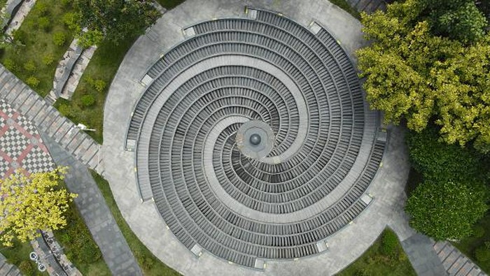 NANNING, CHINA - SEPTEMBER 12, 2022 - An aerial photo shows an ultra-modern giant circular mysterious fountain whirlpool at Jinhu Square in Nanning, South China's Guangxi Zhuang autonomous region, Sept 12, 2022. From the air, the spiral steps twist and rotate, interlocking, just like a profound 