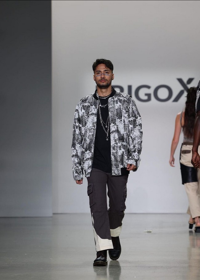 Refal Hady memadukan T-shirt, jaket motif abstrak serta celana bernuansa monokrom. Boots hitam dan kalung rantai melengkapi penampilannya. Foto: Instagram/@erigostore