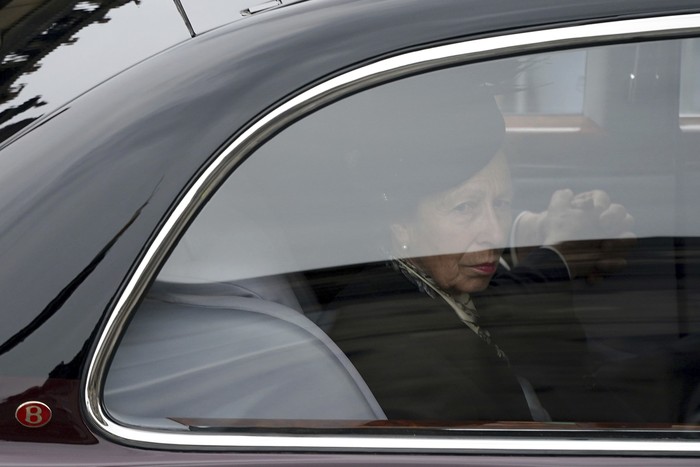 Princess Anne approaches the hearse carrying the coffin of Queen Elizabeth II, draped with the Royal Standard of Scotland, as it arrives at Holyroodhouse, where it will lie in rest for a day, in Edinburgh, Sunday, Sept. 11, 2022. Queen Elizabeth II, Britain's longest-reigning monarch and a rock of stability across much of a turbulent century, died Thursday Sept. 8, 2022, after 70 years on the throne. She was 96. (Alkis Konstantinidis/Pool Photo via AP)