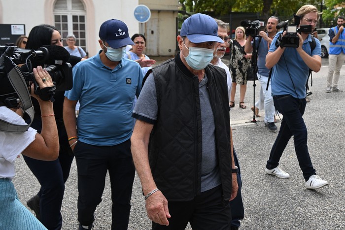 French ex-dentists Lionel (back) and his father Carnot Guedj (2nd R), accused of fraud and dental mutilation arrive at the courthouse on the trial voting and sentencings day in Marseille, southern France, on September 8, 2022. - Lionel Guedj was sentenced on September 8, 2022 in Marseille to eight years in prison with an immediate committal order for having mutilated hundreds of patients, while enriching himself on the Social Security and mutual insurance companies. (Photo by Christophe SIMON / AFP) (Photo by CHRISTOPHE SIMON/AFP via Getty Images)