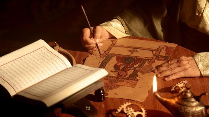 Detail shot of an old and historic Islamic scientist is working in his studio writing, reading and exploring.