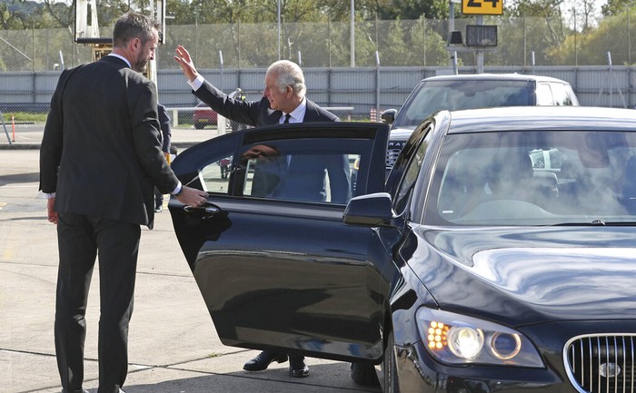 King Charles III waves to onlookers as he arrives at Belfast City Airport Matthew Hall, Ella Smith aged 10, and Lucas Watt aged 10 as they arrive at BelfastCity Airport as the King continues his tour of the four home nations in Northern Ireland, Tuesday Sept. 13, 2022. Charles and Camilla are visiting the four home nations of the UK in the run-up to the state funeral for Queen Elizabeth II on Monday. (Liam McBurney/pool via AP)