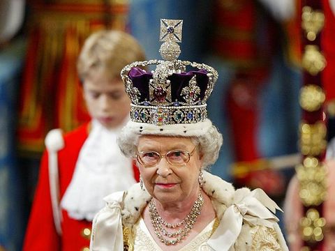 Britain's Queen Elizabeth II, wearing the Imperial Crown, walks in procession through The Royal Gallery on her way to give her speech during the ceremonial state opening of Parliament in London 13 November 2002. WPA POOL