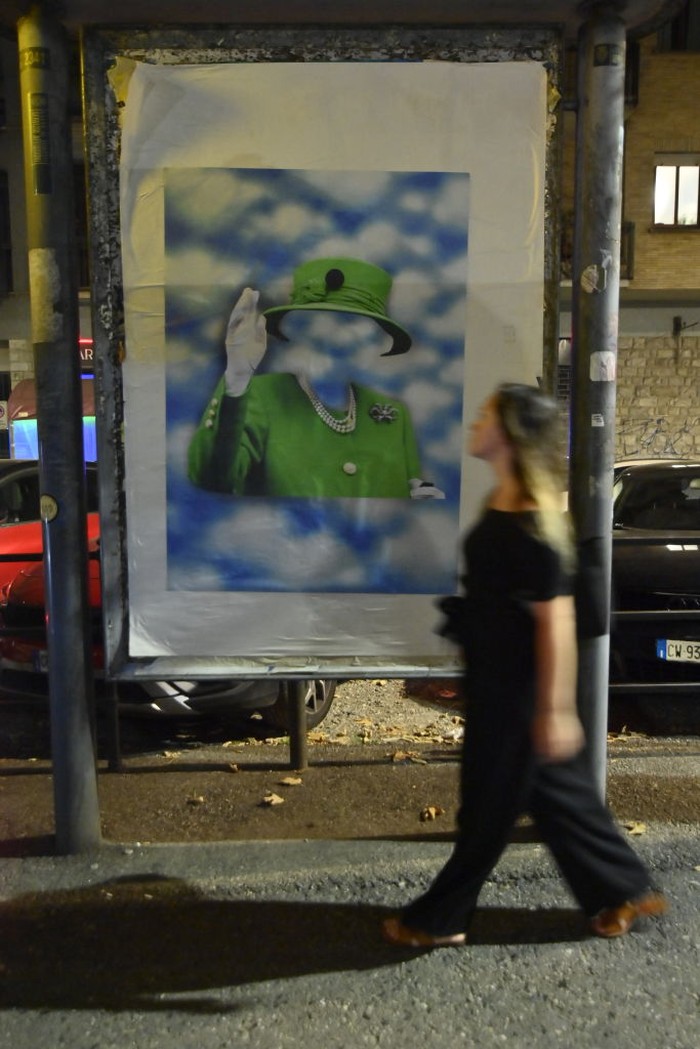 TURIN, ITALY - SEPTEMBER 12: The street artist Andrea Villa arranges a poster created by him commemorating Queen Elizabeth II Death on September 12, 2022 in Turin, Italy. Queen Elizabeth II died at Balmoral Castle in Scotland on September 8, 2022, and is succeeded by her eldest son, King Charles III. (Photo by Stefano Guidi/Getty Images)