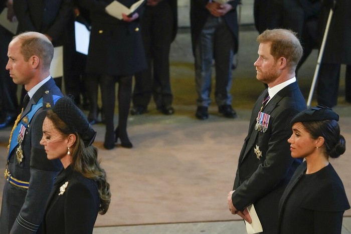 Britain Royals Britain's Kate, Princess of Wales, from left, Prince William, Meghan, Duchess of Sussex and Prince Harry stand in Westminster Hall after participating in the procession of the coffin of Queen Elizabeth, London, Wednesday, Sept. 14, 2022. The Queen will lie in state in Westminster Hall for four full days before her funeral on Monday Sept. 19. (AP Photo/Gregorio Borgia, Pool)