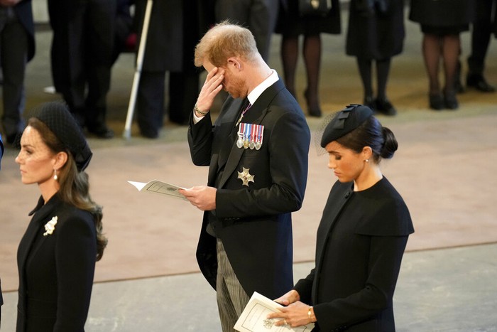Britain Royals Britain's Kate, Princess of Wales, from left, Prince William, Meghan, Duchess of Sussex and Prince Harry stand in Westminster Hall after participating in the procession of the coffin of Queen Elizabeth, London, Wednesday, Sept. 14, 2022. The Queen will lie in state in Westminster Hall for four full days before her funeral on Monday Sept. 19. (AP Photo/Gregorio Borgia, Pool)