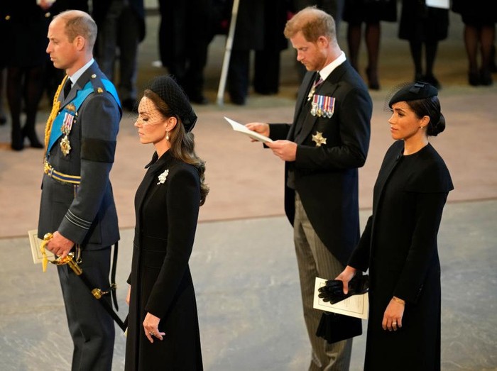 LONDON, ENGLAND - SEPTEMBER 14: Prince William, Prince of Wales, Catherine, Princess of Wales, Prince Harry, Duke of Sussex and Meghan, Duchess of Sussex seen inside the Palace of Westminster during the Lying-in State of Queen Elizabeth II on September 14, 2022 in London, England. Queen Elizabeth IIs coffin is taken in procession on a Gun Carriage of The Kings Troop Royal Horse Artillery from Buckingham Palace to Westminster Hall where she will lay in state until the early morning of her funeral. Queen Elizabeth II died at Balmoral Castle in Scotland on September 8, 2022, and is succeeded by her eldest son, King Charles III.  (Photo by Christopher Furlong/Getty Images)