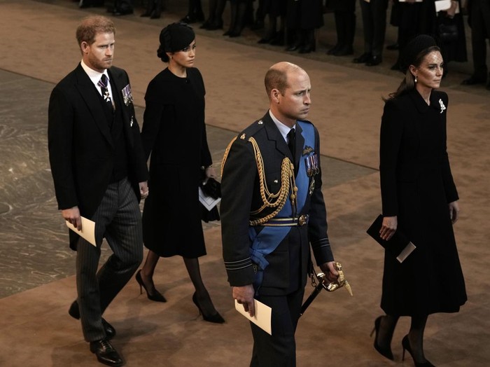 LONDON, ENGLAND - SEPTEMBER 14: Prince Harry, Duke of Sussex and Meghan, Duchess of Sussex, Prince William, Prince of Wales and Catherine, Princess of Wales walk behind the coffin as they arrive in The Palace of Westminster after the procession for the Lying-in State of Queen Elizabeth II on September 14, 2022 in London, England. Queen Elizabeth IIs coffin is taken in procession on a Gun Carriage of The Kings Troop Royal Horse Artillery from Buckingham Palace to Westminster Hall where she will lay in state until the early morning of her funeral. Queen Elizabeth II died at Balmoral Castle in Scotland on September 8, 2022, and is succeeded by her eldest son, King Charles III.  (Photo by Nariman El-Mofty-WPA Pool/Getty Images)