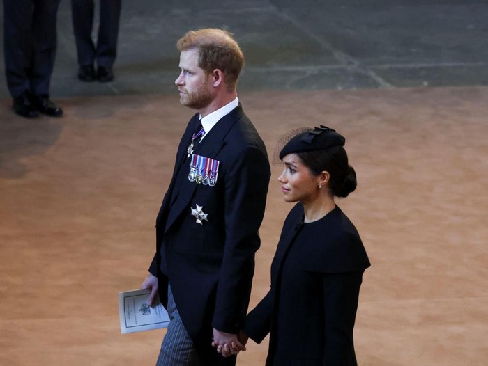 Britains Prince Harry and Meghan, Duchess of Sussex walks as the coffin of Queen Elizabeth II arrives at Westminster Hall in London, Wednesday, Sept. 14, 2022. The Queen will lie in state in Westminster Hall for four full days before her funeral on Monday Sept. 19. (Phil Noble/Pool Photo via AP)
