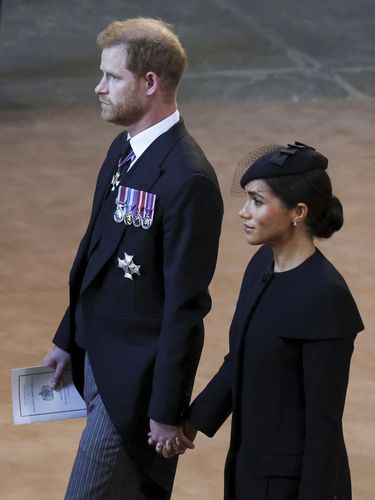 Britain's Prince Harry and Meghan, Duchess of Sussex walks as the coffin of Queen Elizabeth II arrives at Westminster Hall in London, Wednesday, Sept. 14, 2022. The Queen will lie in state in Westminster Hall for four full days before her funeral on Monday Sept. 19. (Phil Noble/Pool Photo via AP)