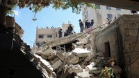Tim penyelamat mencari korban selamat di bawah reruntuhan bangunan yang runtuh di Amman, Yordania, Rabu, (14/9/2022). (Alaa Al Sukhni/Reuters)