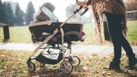 Young mother with a baby stroller