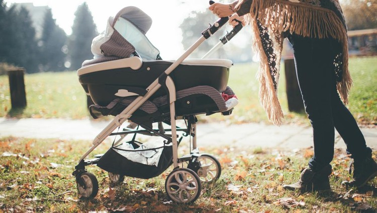 Young mother with a baby stroller