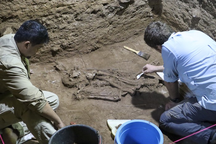 Dr Tim Maloney and Andika Priyatno work at the site in a cave in East Kalimantan, Borneo, Indonesia, March 2, 2020. The remains, which have been dated to 31,000 years old, mark the oldest evidence for amputation yet discovered. And the prehistoric “surgery” could show that humans were making medical advances much earlier than previously thought, according to the study published Wednesday, Sept. 7, 2022 in the journal Nature.  (Tim Maloney/Griffith University via AP)