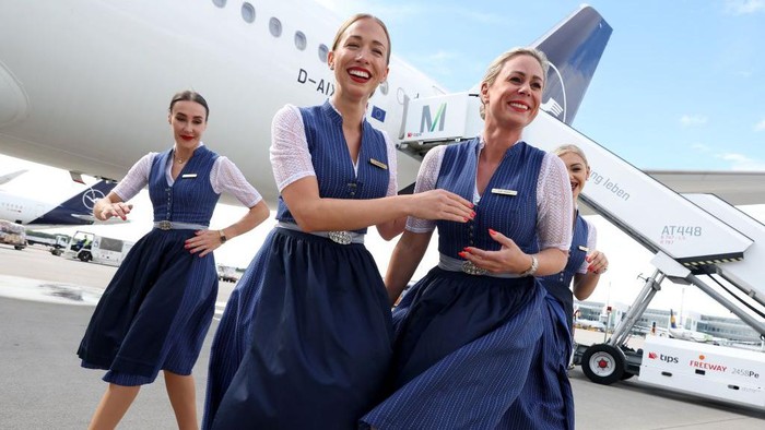 ERDING, GERMANY - SEPTEMBER 15: Flight crews of German airliner Lufthansa wear traditional Bavarian folk dress during a photocall to celebrate Oktoberfest at Munich Airport Franz-Joseph-Strauss International on September 15, 2022 in Erding, Germany. Lufthansa cabin crew will dress in the Bavarian traditional costume  