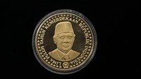 (2) a.Sisi Belakang. Ada tulisan Lima Puluh Tahun Kemerdekaan Indonesia. Gambar utama Bapak Soeharto. Gambar 50 buah bintang melingkari gambar utama. Ada gambar Logo DHN-45. Bahan emas kuning kadar 23 karat, berat 50 gram.Foto: Sylke Febrina Laucereno/detikcom