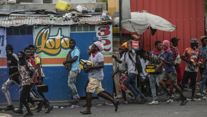 Polices secure a gas station during a protest against fuel price hikes and to demand that Haitian Prime Minister Ariel Henry step down, in Port-au-Prince, Haiti, Friday, Sept. 16, 2022. (AP Photo/Odelyn Joseph)