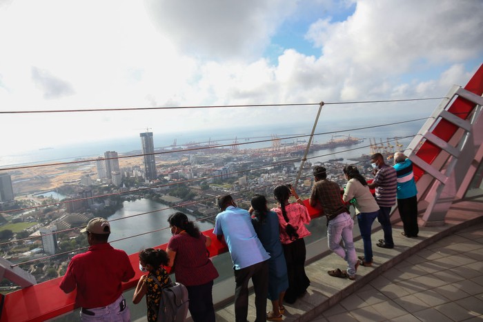 Visitors take pictures in front of the Sri Lankan 'white elephant' Chinese-built Lotus Tower after it was opened for public in Colombo on September 15, 2022. (Photo by Ishara S. KODIKARA / AFP) (Photo by ISHARA S. KODIKARA/AFP via Getty Images)