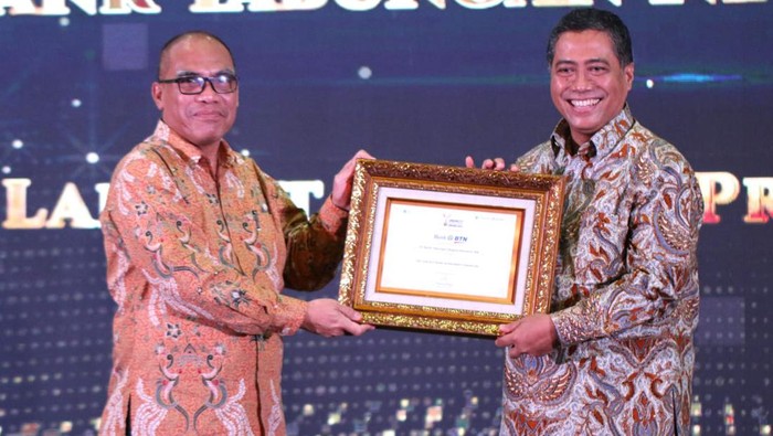 Direktur Consumer PT Bank Tabungan Negara (Persero) Tbk. Hirwandi Gafar (tengah) tersenyum saat menerima penghargaan 
