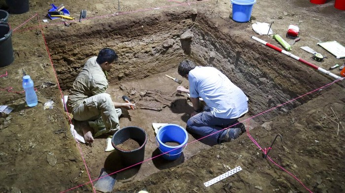 Fosil di Kalimantan Ini Jadi Bukti Amputasi Pertama di Dunia Dr Tim Maloney and Andika Priyatno work at the site in a cave in East Kalimantan, Borneo, Indonesia, March 2, 2020. The remains, which have been dated to 31,000 years old, mark the oldest evidence for amputation yet discovered. And the prehistoric “surgery” could show that humans were making medical advances much earlier than previously thought, according to the study published Wednesday, Sept. 7, 2022 in the journal Nature. (Tim Maloney/Griffith University via AP)