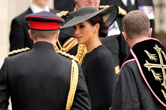 LONDON, ENGLAND - SEPTEMBER 19: Meghan, Duchess of Sussex arrives at Westminster Abbey for The State Funeral of Queen Elizabeth II on September 19, 2022 in London, England. Elizabeth Alexandra Mary Windsor was born in Bruton Street, Mayfair, London on 21 April 1926. She married Prince Philip in 1947 and ascended the throne of the United Kingdom and Commonwealth on 6 February 1952 after the death of her Father, King George VI. Queen Elizabeth II died at Balmoral Castle in Scotland on September 8, 2022, and is succeeded by her eldest son, King Charles III.  (Photo by Christopher Furlong/Getty Images)