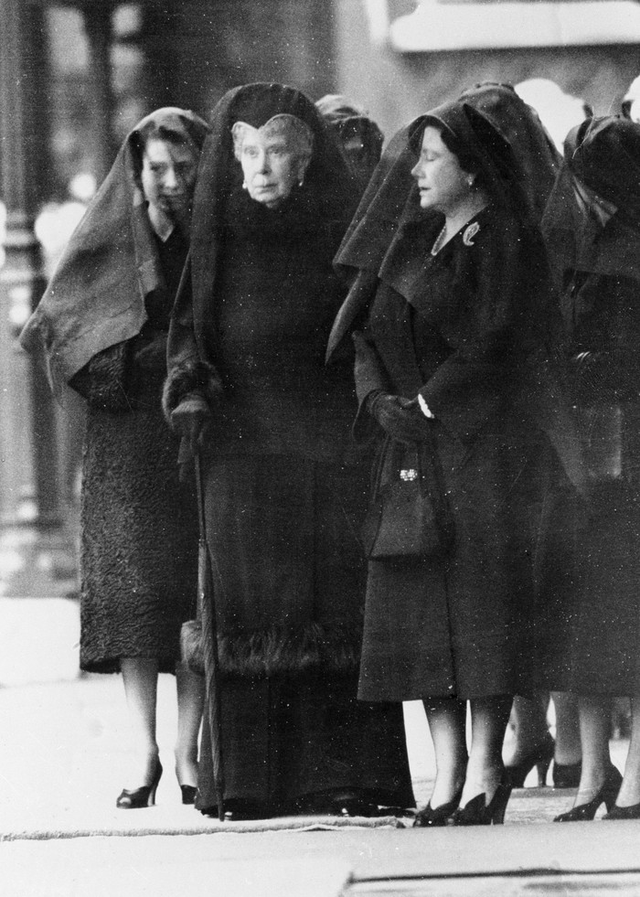 Left to right: Queen Elizabeth, Queen Elizabeth the Queen Mother, widow of King George VI, and Queen Mary at London Kings Cross railway station for the arrival of the special train bringing the coffin of King George VI from Sandringham, 11th February 1952. The kings coffin will be drawn in procession to Westminster Hall, where it is to lie in state for three days before the funeral.