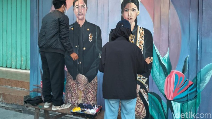 Seniman membuat mural Kaesang-Erina Gudono di Kota Solo, Seniin (19/9/2022).