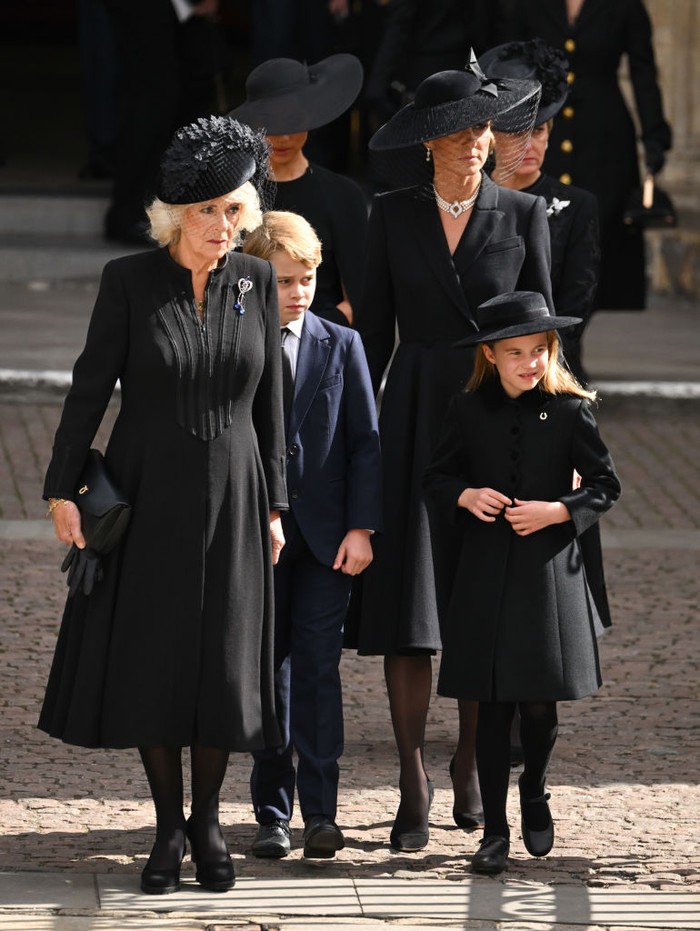 Meghan Markle LONDON, ENGLAND - SEPTEMBER 19: (L-R) Camilla, Queen Consort, Meghan, Duchess of Sussex, Prince George of Wales, Catherine, Princess of Wales, Princess Charlotte of Wales and Sophie, Countess of Wessex during the State Funeral of Queen Elizabeth II at Westminster Abbey on September 19, 2022 in London, England. Elizabeth Alexandra Mary Windsor was born in Bruton Street, Mayfair, London on 21 April 1926. She married Prince Philip in 1947 and ascended the throne of the United Kingdom and Commonwealth on 6 February 1952 after the death of her Father, King George VI. Queen Elizabeth II died at Balmoral Castle in Scotland on September 8, 2022, and is succeeded by her eldest son, King Charles III. (Photo by Karwai Tang/WireImage)