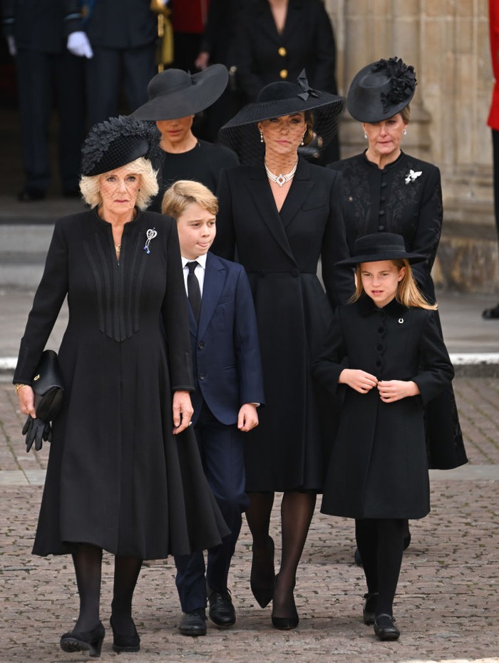 Meghan Markle LONDON, ENGLAND - SEPTEMBER 19: (L-R) Camilla, Queen Consort, Meghan, Duchess of Sussex, Prince George of Wales, Catherine, Princess of Wales, Princess Charlotte of Wales and Sophie, Countess of Wessex during the State Funeral of Queen Elizabeth II at Westminster Abbey on September 19, 2022 in London, England. Elizabeth Alexandra Mary Windsor was born in Bruton Street, Mayfair, London on 21 April 1926. She married Prince Philip in 1947 and ascended the throne of the United Kingdom and Commonwealth on 6 February 1952 after the death of her Father, King George VI. Queen Elizabeth II died at Balmoral Castle in Scotland on September 8, 2022, and is succeeded by her eldest son, King Charles III. (Photo by Karwai Tang/WireImage)