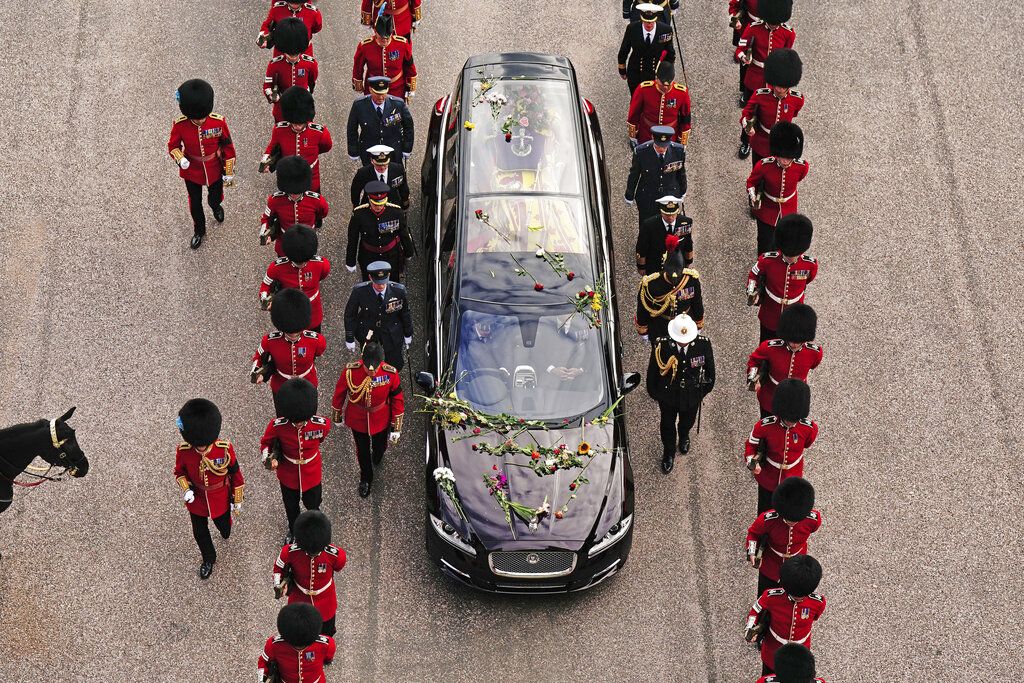 Flowers on the hearse carrying the coffin of Queen Elizabeth II as it arrives at Windsor Castle for the Committal Service in St George's Chapel, in Windsor, England, Monday, Sept. 19, 2022. (Aaron Chown/Pool photo via AP)