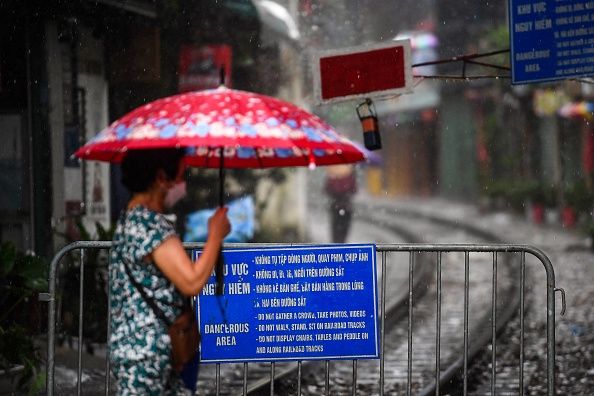 A resident walks on Hanoi's popular train street on September 16, 2022, following the announcement of its closure over safety concerns. - Snap-happy tourists and cafe owners along Hanoi's popular 'train street' spoke of their disappointment as the Instagram hotspot was blocked off due to safety concerns just weeks after reopening following a long Covid closure. (Photo by Nhac NGUYEN / AFP) (Photo by NHAC NGUYEN/AFP via Getty Images)