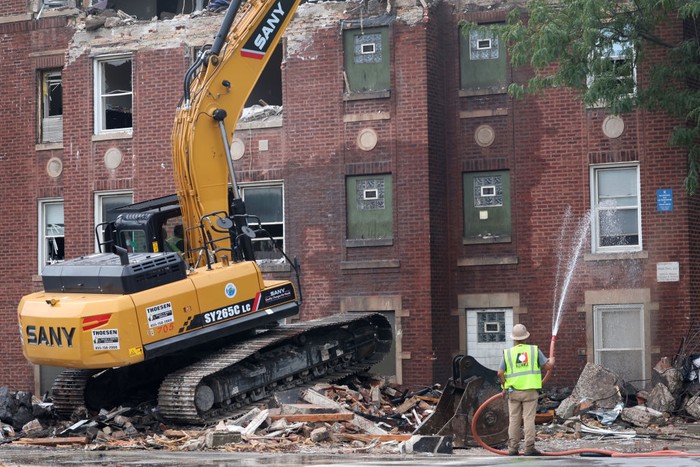 CHICAGO, ILLINOIS - SEPTEMBER 20: Workers clean up and secure an apartment building that was heavily damaged by an explosion on September 20, 2022 in Chicago, Illinois. The cause of the explosion remains unknown. Eight people were transported to area hospitals following the blast. (Photo by Scott Olson/Getty Images)