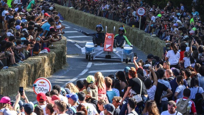 A team competes in the Red Bull Soapbox race in Toulouse on September 18, 2022. - The Red Bull Soapbox race is an event where amateur drivers race with their homemade soapbox vehicles down a 530m hill through obstacles. (Photo by Charly TRIBALLEAU / AFP) (Photo by CHARLY TRIBALLEAU/AFP via Getty Images)