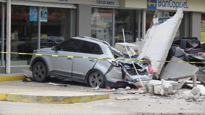 Wajah Meksiko Usai Diguncang Gempa M 7,7 Vehicles damaged by the collapse of the facade of a department store during an earthquake are pictured in Manzanillo, Mexico September 19, 2022. REUTERS/Jesus Lozoya NO RESALES. NO ARCHIVES