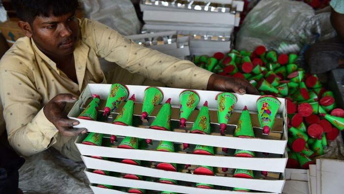 Workers lay out firecrackers for drying outside a workshop ahead of 'Diwali' festival on the outskirts of Ahmedabad on September 21, 2022. (Photo by SAM PANTHAKY / AFP) (Photo by SAM PANTHAKY/AFP via Getty Images)