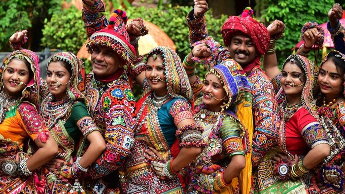 Participants from an art group wearing traditional dresses pose for pictures during Garba dance rehearsals ahead of the Navratri festival in Ahmedabad on September 20, 2022. (Photo by SAM PANTHAKY / AFP) (Photo by SAM PANTHAKY/AFP via Getty Images)