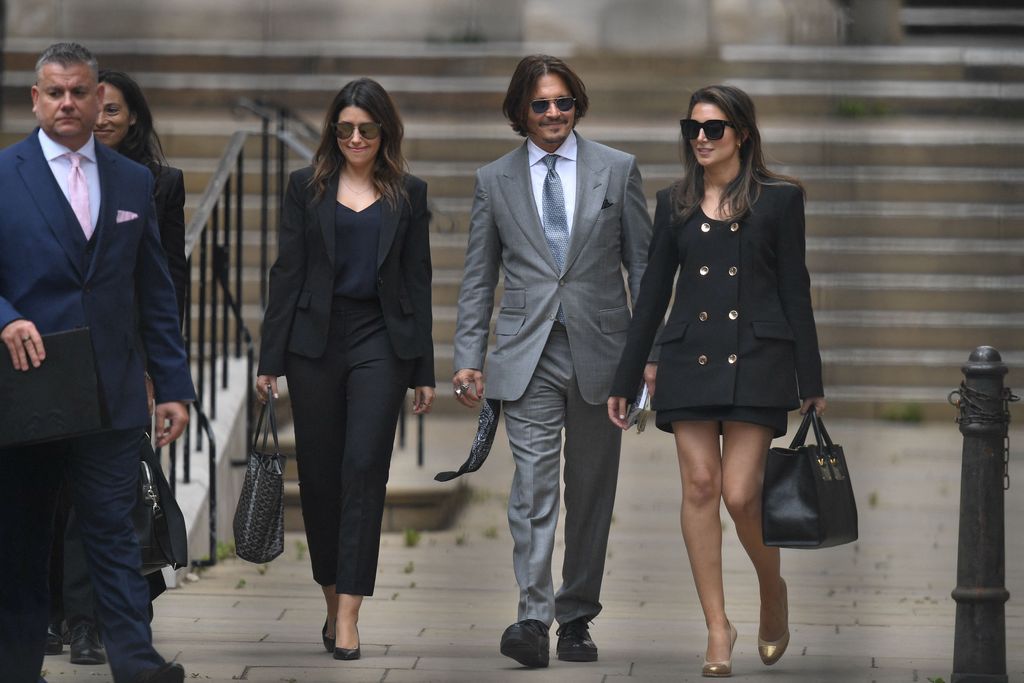 US actor Johnny Depp (C) leaves with members of his team after day eight of his libel trial against News Group Newspapers (NGN) at the High Court in London, on July 16, 2020. - Depp is suing the publishers of The Sun and the author of the article for the claims that called him a 