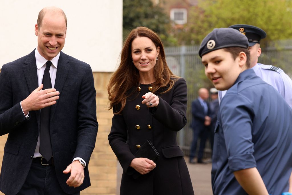 Britain's Prince William, Duke of Cambridge, and Britain's Catherine, Duchess of Cambridge, wearing black as a mark of respect following the death of Britain's Prince Philip, Duke of Edinburgh, meet air Cadets during their visit to 282 (East Ham) Squadron Air Training Corps in east London on April 21, 2021. - During the visit, the Squadron paid tribute to The Duke of Edinburgh, who served as Air Commodore-in-Chief of the Air Training Corps for 63 years. In 2015, The Duke passed the military patronage to The Duchess of Cambridge who became Honorary Air Commandant. (Photo by Ian Vogler / POOL / AFP) (Photo by IAN VOGLER/POOL/AFP via Getty Images)