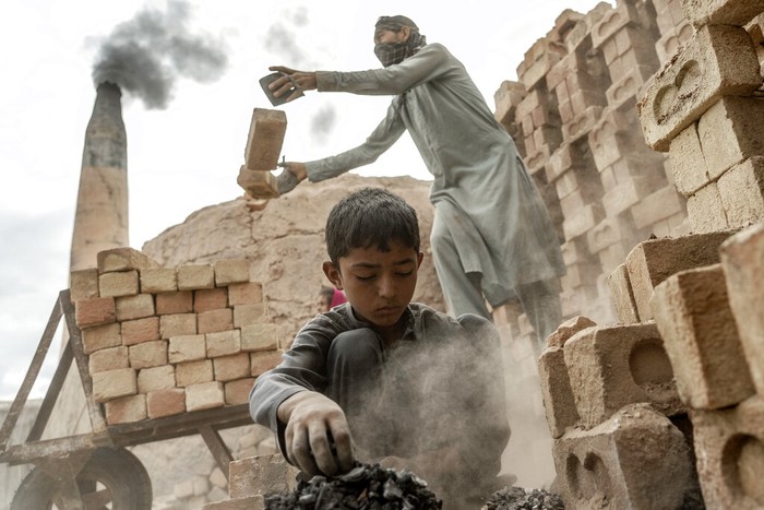 A 9-year-old Afghan girl works in a brick factory on the outskirts of Kabul, Afghanistan, Monday, Sept. 12, 2022. Aid agencies say the number of children working in Afghanistan is growing ever since the economy collapsed following the Taliban takeover more than a year ago. (AP Photo/Ebrahim Noroozi)
