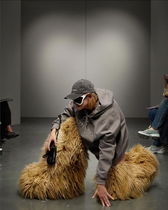 ‘Looking Rich’ menjadi tema utama koleksi ini. Direpresentasikan dalam gaya berlebihan dan dramatis seperti boots selutut aksen bulu, mantel tebal dan panjang, hoodie kebesaran hingga swimsuit berlogo $$. Foto: Instagram/@avavav